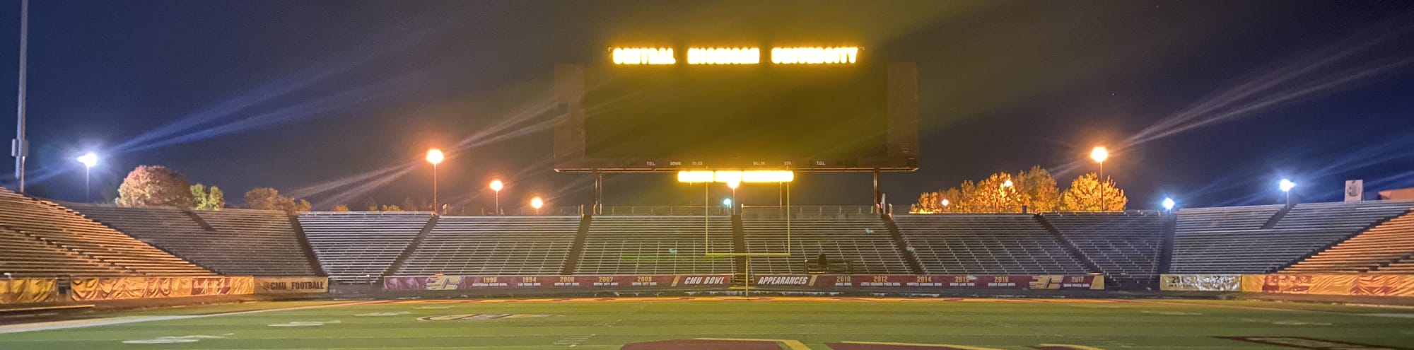 empty football stadium at night under the lights Fayetteville